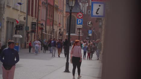 Numerous-people-are-walking-in-the-street-of-Kraków,-Poland