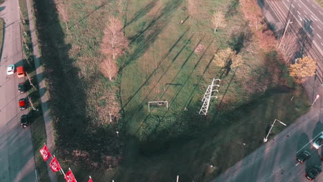 Flying-over-a-fun-soccerfield-with-kids-playing-football-in-times-of-lockdown-in-Germany,-Europe