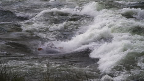 Local-Ugandan-kayaker-surfing-and-doing-tricks-on-a-big-wave-on-river-Nile,-Jinja-Uganda