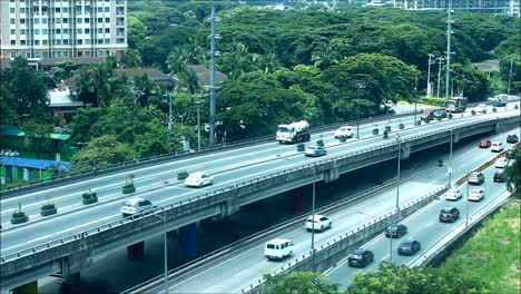 PASIG-CITY,-PHILIPPINES-–-JULY-9,-2019:-Steady-video-shot-of-private-and-public-vehicles-passing-along-a-flyover-at-a-major-road-in-Pasig-City