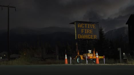 Grand-Lake-Fire-Dept-drives-past-wild-fire-evacuation-sign-at-dusk