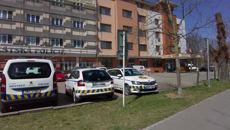 Police-station-with-parked-police-cars-and-police-officers-around-in-the-city-of-Olomouc,-Czech-Republic