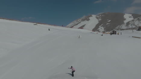 Snowboarder-jumps-from-snow-kicker-at-the-slopes-of-Mount-Hermon,-Golan-Heights,-Israel,-drone-view