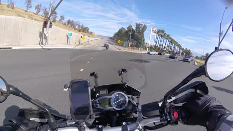 POV-riding-motorcycle-to-ramp-leading-to-freeway-15-in-Fontana,-California