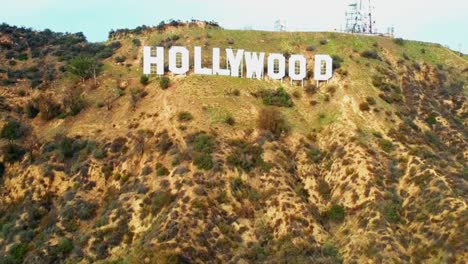 Aerial,-pushing,-drone-shot,-of-the-Hollywood-sign,-on-Mount-Lee,-the-Santa-Monica-Mountains,-on-a-sunny-day,-in-Los-Angeles,-California