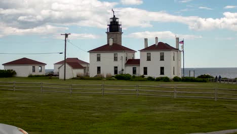 Hyperlapse-of-a-lighthouse-with-white-buildings-in-the-countryside-on-a-bright-and-sunny-day