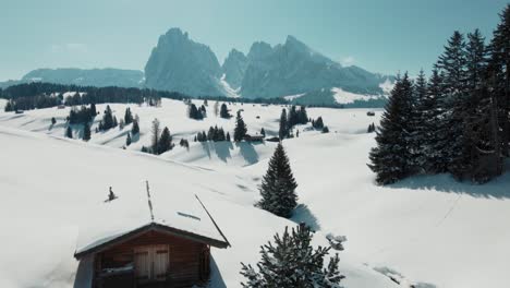 Meadow-with-hut-and-mountain-view-in-winter