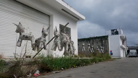 paper-mache-unicorn-piñata's-drying-on-line-in-the-sun