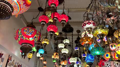 Colorful-and-bright-Turkish-ceiling-lamps-and-chandeliers-hanging-from-the-ceiling-of-a-Turkish-Fine-Arts-Gallery-and-store-in-Carmel-by-the-Sea,-a-popular-tourist-destination-and-arts-town