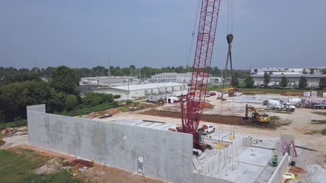 ascending-aerial-view-of-crane-on-construction-site