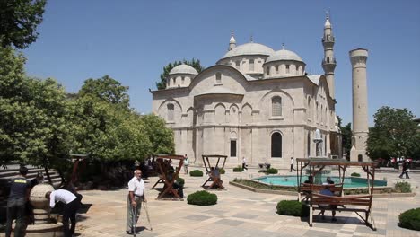 MALATYA---TURKEY---JULY-7,-2017:-PEOPLE-SITTING-IN-THE-PARK-IN-FRONT-OF-THE-NEW-MOSQUE