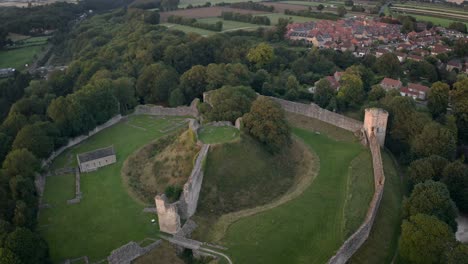 Aerial-shot-of-Pickering-Castle-at-sunset,-showing-the-Motte-and-Bailey-keep,-outer-wall-defences,-and-other-structures