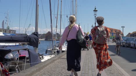 Two-friends-walking-on-the-streets-of-Copenhagen-on-a-summer-day