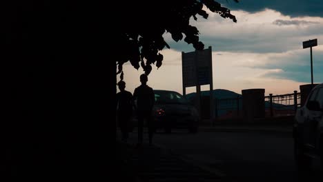 Silhouette-Of--Two-Boys-Walking-In-The-Dark