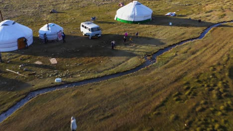 Native-Mongolian-people-living-in-ger-tents-in-remote-Altai-Mountains,-aerial