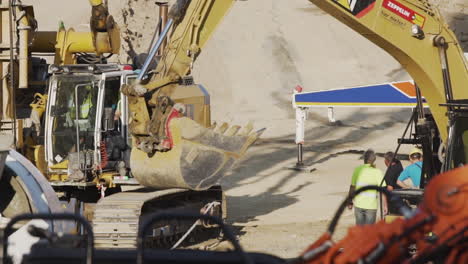 Excavator-arm-on-a-construction-site-in-Vienna,-Austria,-moving-into-position-for-unloading-dirt