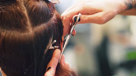 Close-up-view-of-stylist-cutting-hair