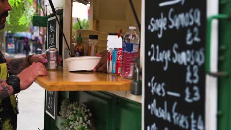 Man-serving-takeaway-to-customer-on-a-food-truck