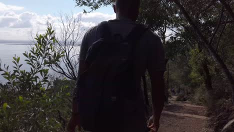 Black-man-hiking-on-a-beautiful-walking-track-in-a-Nationalpark-near-Port-Stephens