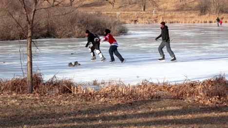 Several-friends-play-competitively-pond-hockey-on-a-frozen-lake