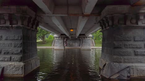 Swan-boat-travels-under-bridge