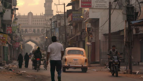 A-busy-street-in-india-with-people-walking,-riding-bikes,-and-driving-cars