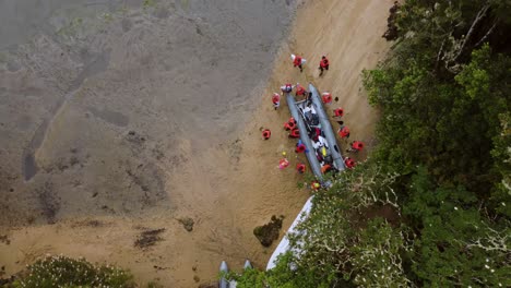 Orbit-Shot-Of-People-Anchoring-Their-Boat-On-Dry-Land-Going-For-Camping,-California