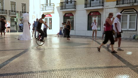 Street-theater-and-juggling-as-a-profession-and-lifestyle,-two-young-people-do-a-street-show-on-their-bicycles,-Rua-Augusta