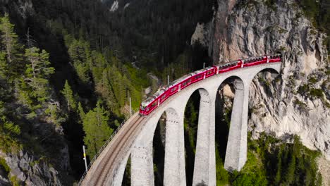 Aerial:-red-train-on-the-Landwasser-viaduct