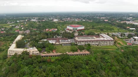 Nice-drone-aerial-view-of-the-cityscape-and-the-fun-theme-park-from-Sky-ranch,-big-ferris-wheel,-tower-and-skylines-in-the-top-of-the-mountains-of-Tagaytay-City