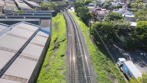 Aerial-shot-over-the-train-track-tilt-up-and-revealing-the-city