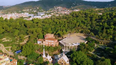 Aerial-view-overlooking-the-Park-Guell,-Barcelona,-Spain,-during-golden-hour---dolly,-drone-shot