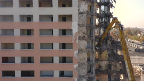 Demolition-of-a-concrete-apartment-building-with-a-hydraulic-excavator