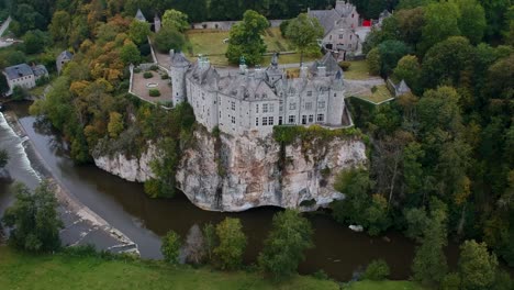 Overhead-shot-of-Walzin-castle-surrounded-by-a-river-and-wood