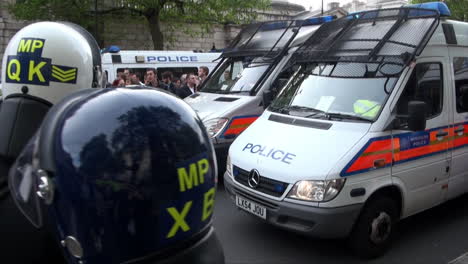 Officers-from-the-Metropolitan-Territorial-Support-Group-wearing-Nato-helmets-stand-and-watch-as-police-vans-draw-forwards-to-form-a-line-on-Whitehall-during-scenes-of-unrest