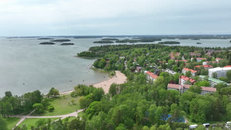 Aerial-view-orbiting-the-Kasinonranta-beach,-summer-day-in-Lauttasaari,-Finland