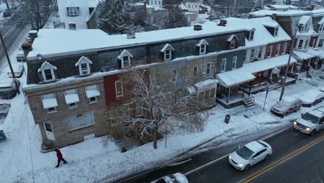 Walking-pedestrian-on-snowy-sidewalk-in-american-neighborhood