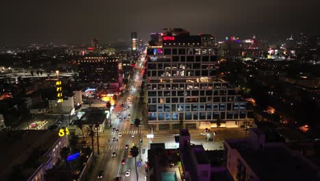 Los-Angeles,-California-at-nighttime-with-a-view-of-the-Netflix-Sunet-Bronson-Studios---nighttime-aerial-reveal