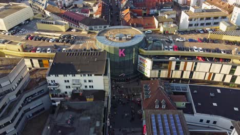 Downtown-crowded-with-people-shopping-at-Kaiserslautern-city-mall-for-Christmas,-Drone-view