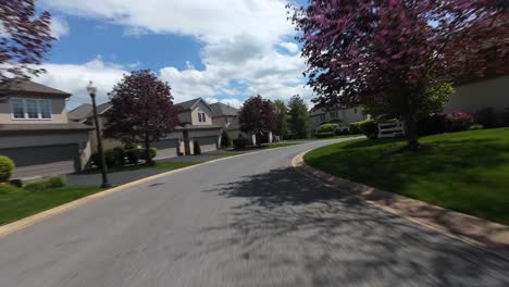 Fpv-drone-flight-over-luxury-neighborhood-of-USA-with-blooming-trees-in-spring-season