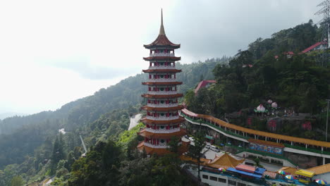 Drone-tilting-away-from-the-Chin-Swee-Caves-Temple,-in-the-Genting-Highlands-of-Malaysia