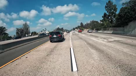 First-person-view-on-motorcycle-driving-through-cars-on-freeway