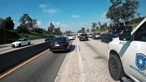 Driving-on-freeway-through-afternoon-city-traffic-on-freeway