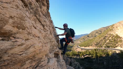 Sportsmen-rock-climbing-aerial-view-of-sportsman-rapelling-mountain-in-La-Panocha,-el-Valle-Murcia,-Spain-woman-rapel-down-a-mountain-climbing-a-big-rock