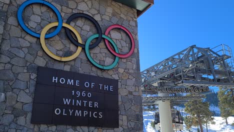 Palisades-Ski-Resort,-Former-Home-of-1960-Winter-Olympics,-Sign-on-Buildings-and-Ski-Gondola-Lift