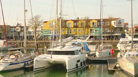 Profile-view-of-"Le-Gabut"-district-with-local-boats-parked-at-harbour,-Nordic-architecture-in-La-Rochelle,-France