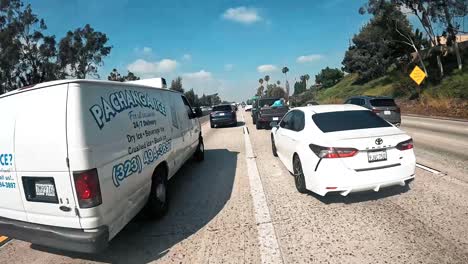 First-person-point-of-view-splitting-lanes-in-the-afternoon-on-a-motorcycle