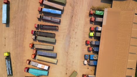 Top-down-bird's-eye-view-of-cargo-trucks-in-the-Boten-Special-Economic-Zone,-Laos,-near-the-China-border