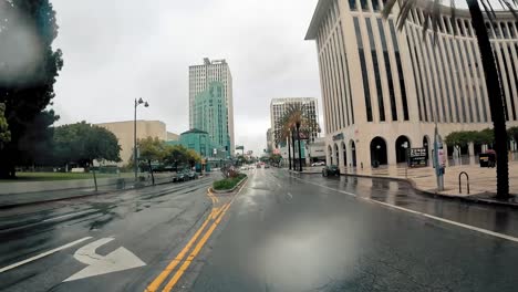 Motorcyclist-point-of-view-driving-through-urban-streets-on-rainy-day