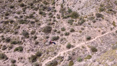 Sportsmen-ziplining-aerial-view-of-sportsman-in-zipline-amidst-mountain-in-Murcia,-Spain